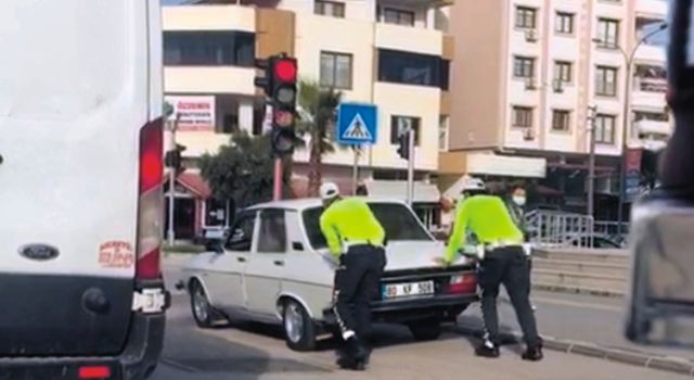 Trafik polisleri, yolda kalan sürücüye, aracını iterek yardım etti