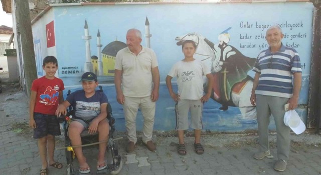 Burhaniye de evin duvarındaki anlamlı resim ve yazı ilgi odağı oldu