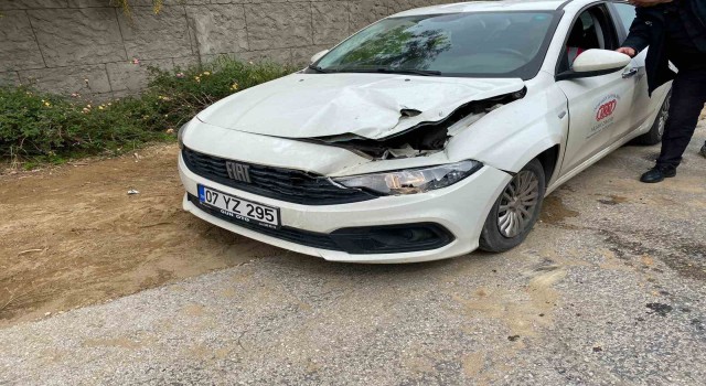 Devrilen iş makinesinin kepçesi otomobilin kaputunun üzerine düştü