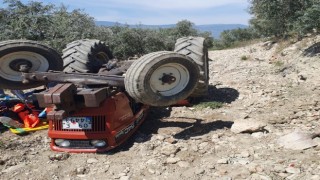 Devrilen traktörün altından yardım istedi