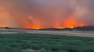 Komşudaki yangın rüzgarın etkisiyle yayılmaya devam ediyor